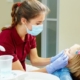 dentist looking into childs mouth